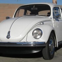 Car features replacement upholstery colour, aftermarket steering wheel and front spoiler not part of the original edition package.