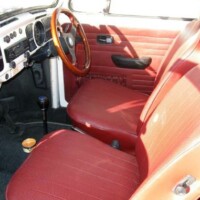 Car features replacement upholstery colour, aftermarket steering wheel and front spoiler not part of the original edition package.